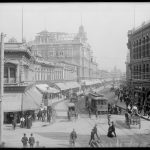 shoppers walking along a busy retail street