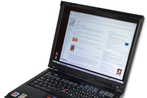 A tablet and laptop sit side by side on a tidy study desk with notebooks.