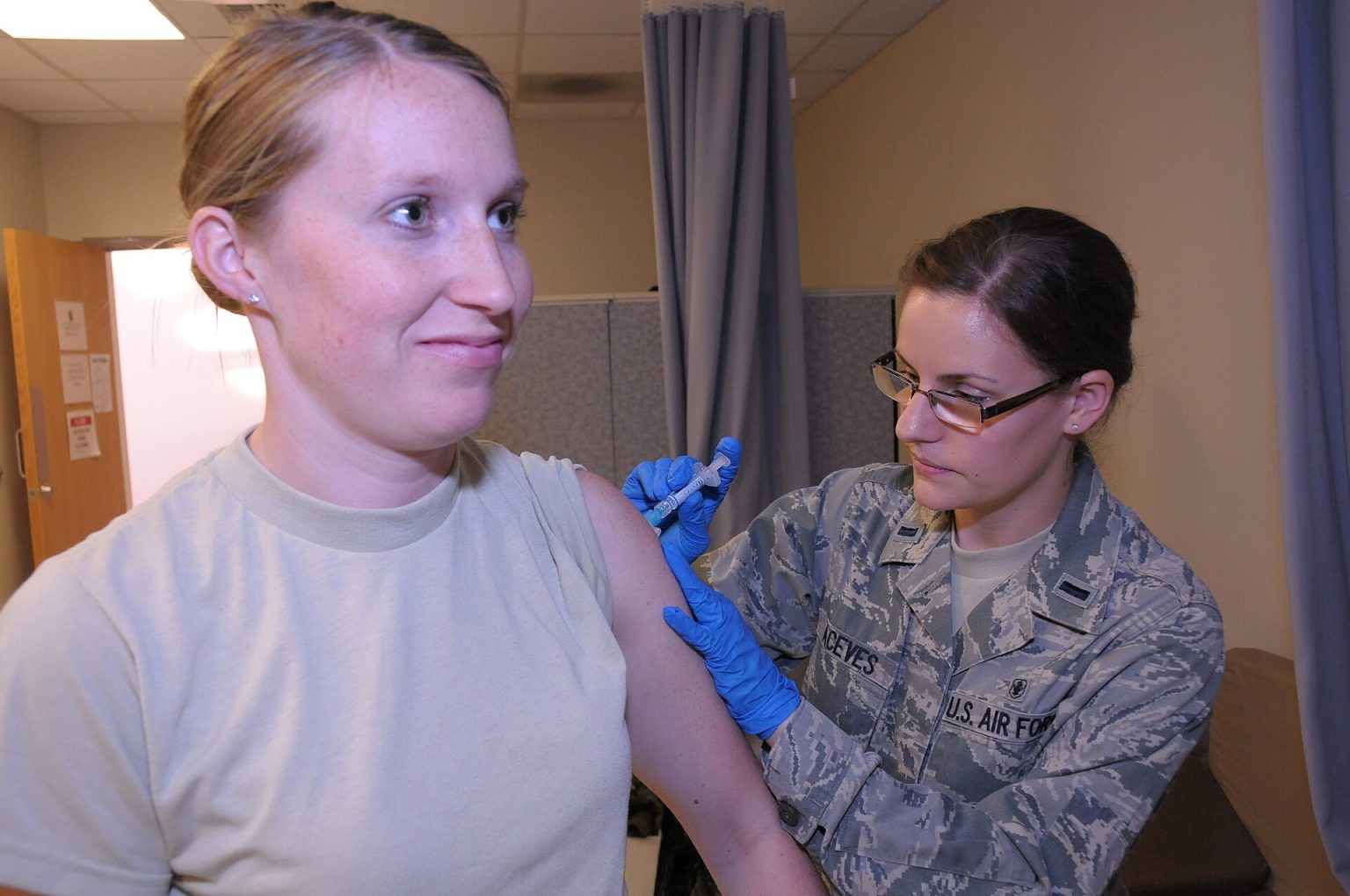 Healthcare worker preparing a measles vaccine dose at a clinic