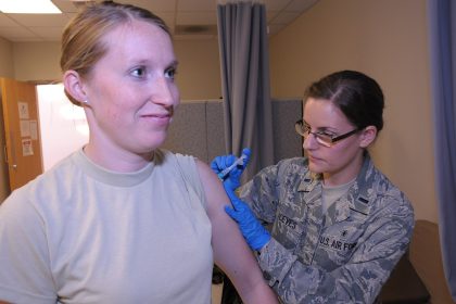 Healthcare worker preparing a measles vaccine dose at a clinic